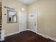 Inviting entryway with a mirror, white doors, neutral paint, and hardwood floors at 4484 S Granby Ct, Aurora, CO 80015