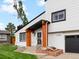 Inviting home exterior featuring a garage, landscaped yard, and natural wood porch supports at 4484 S Granby Ct, Aurora, CO 80015