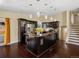 Modern kitchen with dark cabinets, stainless appliances, and a large island at 4484 S Granby Ct, Aurora, CO 80015