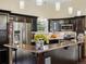 This modern kitchen features dark wood cabinets, stainless steel appliances, and hanging lights at 4484 S Granby Ct, Aurora, CO 80015