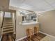 Cozy kitchenette with seating area, ample counter space, and a pass-through to another room at 4484 S Granby Ct, Aurora, CO 80015