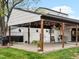 The outdoor patio includes hanging lights, potted plants, seating, and a barbecue at 4484 S Granby Ct, Aurora, CO 80015