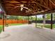 This large outdoor patio includes hanging lights, a barbecue, a bench, and flowerpots at 4484 S Granby Ct, Aurora, CO 80015