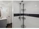 Shower featuring subway tile, black accent stripe, and a modern shower caddy at 4484 S Granby Ct, Aurora, CO 80015