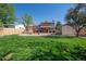 Expansive backyard with lush green grass, mature trees, a patio area, and storage shed at 9700 W 88Th Pl, Westminster, CO 80021