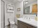 Bathroom featuring a modern vanity, framed mirror, toilet, and a glass enclosed shower at 9700 W 88Th Pl, Westminster, CO 80021