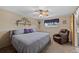 The bedroom showcases a plush armchair, shelving for decor, and natural light at 9700 W 88Th Pl, Westminster, CO 80021