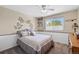 Comfortable bedroom featuring a decorative wall, natural light from the window, and built in shelves at 9700 W 88Th Pl, Westminster, CO 80021