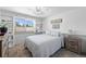 Bright bedroom featuring built-in shelves, a queen-sized bed, and a window with scenic views at 9700 W 88Th Pl, Westminster, CO 80021