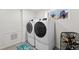 This well-lit laundry room includes modern washer and dryer units, with a window to let in sunlight at 9700 W 88Th Pl, Westminster, CO 80021