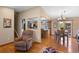 Open concept living and dining room with hardwood floors, a ceiling fan, and a view into the kitchen at 9700 W 88Th Pl, Westminster, CO 80021