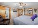 Relaxing bedroom with a ceiling fan, ensuite bathroom, television, and plush seating at 9700 W 88Th Pl, Westminster, CO 80021