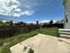 A backyard with a concrete patio and grass that is overgrown at 2033 Espana Way, Aurora, CO 80011