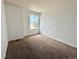 A carpeted bedroom has a large window at 2033 Espana Way, Aurora, CO 80011