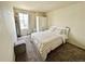 Bright bedroom features a large window and neutral decor at 2033 Espana Way, Aurora, CO 80011