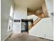 View of the bright entryway showcasing the hardwood staircase and large windows at 2033 Espana Way, Aurora, CO 80011