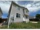 View of the side and back of this two-story home with vinyl siding at 2033 Espana Way, Aurora, CO 80011