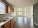 Open kitchen features wood cabinets and a tile floor that extends into the bright dining area at 2033 Espana Way, Aurora, CO 80011