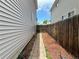A brick walkway between two houses leads to a backyard at 2033 Espana Way, Aurora, CO 80011