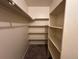 This walk-in closet has shelving and a place to hang clothes, maximizing storage space at 2033 Espana Way, Aurora, CO 80011