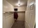 This walk-in closet has built-in storage and a place to hang clothes. A small TV is mounted high in the closet at 2033 Espana Way, Aurora, CO 80011