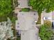 Aerial view of a home with a well-kept roof, driveway, and verdant surrounding trees providing privacy and shade at 3086 W 107Th Pl # F, Westminster, CO 80031