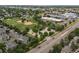 Aerial view of a baseball park, with tree lined street and surrounding buildings in the distance at 3086 W 107Th Pl # F, Westminster, CO 80031