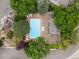 Aerial view of the community pool, lounge chairs, and a pergola covered deck surrounded by mature trees at 3086 W 107Th Pl # F, Westminster, CO 80031