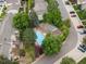 Overhead shot of community pool featuring lounge chairs and a pergola, nestled among well-kept landscaping and homes at 3086 W 107Th Pl # F, Westminster, CO 80031