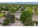 An aerial view showcasing a residential area with lush greenery and mountain views at 3086 W 107Th Pl # F, Westminster, CO 80031