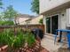 Charming backyard with lush greenery, wooden fence, covered grill, and sliding glass door at 3086 W 107Th Pl # F, Westminster, CO 80031
