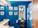 Bathroom features bright blue paint, a decorative shower curtain, and unique artwork at 3086 W 107Th Pl # F, Westminster, CO 80031