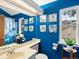 Bright blue bathroom features unique artwork, nautical theme, and a decorative mirror at 3086 W 107Th Pl # F, Westminster, CO 80031