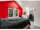 Spacious bedroom with a red accent wall, desk, and plenty of natural light from three windows at 3086 W 107Th Pl # F, Westminster, CO 80031