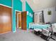 Bright teal bedroom featuring grey carpet, a rocker, and natural light at 3086 W 107Th Pl # F, Westminster, CO 80031