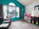 Bright bedroom with chair, dollhouse, large window, and soft neutral carpet at 3086 W 107Th Pl # F, Westminster, CO 80031