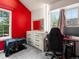 Bedroom offers neutral carpet, natural light, a large dresser, and a red accent wall at 3086 W 107Th Pl # F, Westminster, CO 80031