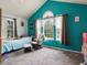 Bright teal bedroom with large windows and neutral carpet and decor at 3086 W 107Th Pl # F, Westminster, CO 80031