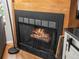 Close-up of a wood-burning fireplace with decorative screen and wooden surround at 3086 W 107Th Pl # F, Westminster, CO 80031