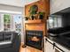 Stylish living room with modern fireplace, wood paneling, and cozy lighting at 3086 W 107Th Pl # F, Westminster, CO 80031