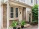 Inviting townhome entrance with a brick facade, potted plants, and a charming front door at 3086 W 107Th Pl # F, Westminster, CO 80031