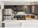 Well-lit kitchen featuring stainless steel appliances, tiled backsplash, and dark cabinetry at 3086 W 107Th Pl # F, Westminster, CO 80031
