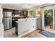 Charming kitchen with dark cabinets, stainless steel appliances, and sliding glass doors to a patio at 3086 W 107Th Pl # F, Westminster, CO 80031