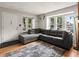Cozy living room with plush gray sectional, wood floors, and bright windows at 3086 W 107Th Pl # F, Westminster, CO 80031