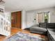 Cozy living area featuring a gray sectional sofa, front door, and wood-look floors at 3086 W 107Th Pl # F, Westminster, CO 80031