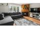Inviting living room featuring a gray sofa, stylish rug, and warm fireplace at 3086 W 107Th Pl # F, Westminster, CO 80031