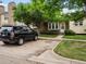 Exterior view of a townhome featuring a parking area and mature tree at 3086 W 107Th Pl # F, Westminster, CO 80031