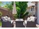 Outdoor seating area with a fire pit, neutral colored cushions, and patio umbrella on a stained wood deck at 3102 Fox Sedge Pl, Highlands Ranch, CO 80126