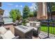 Comfortable back deck features plenty of seating with a water feature backdrop and a hot tub at 3102 Fox Sedge Pl, Highlands Ranch, CO 80126