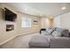 Cozy basement featuring a large sectional sofa and entertainment center, perfect for relaxation at 3102 Fox Sedge Pl, Highlands Ranch, CO 80126